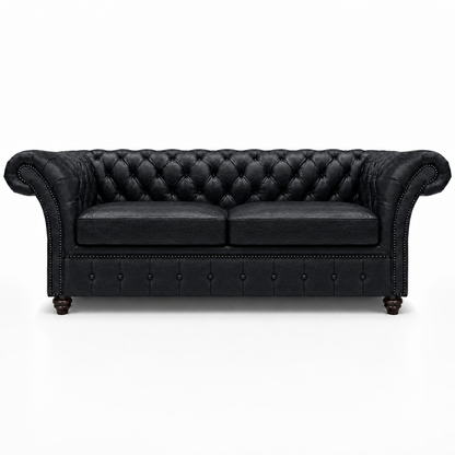 Black leather sofa with tufted backrest on a white background
