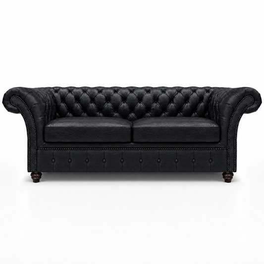 Black leather sofa with tufted backrest on a white background