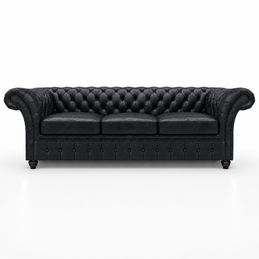 Black leather sofa with tufted backrest on a white background