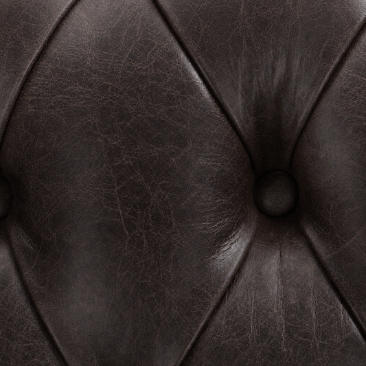 Close-up of a brown leather buttoned cushion