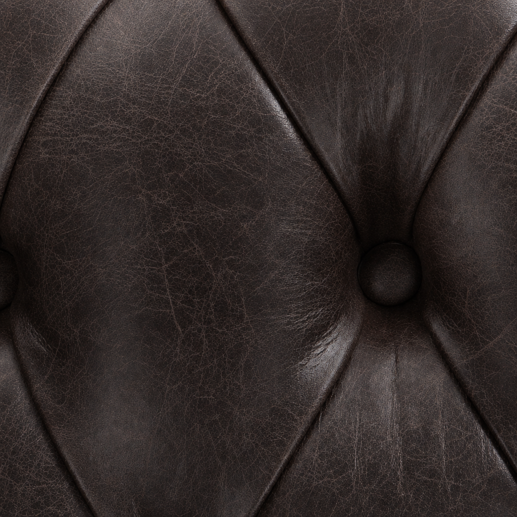 Close-up of a brown leather buttoned cushion