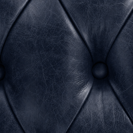 Close-up of a dark blue leather texture with stitching