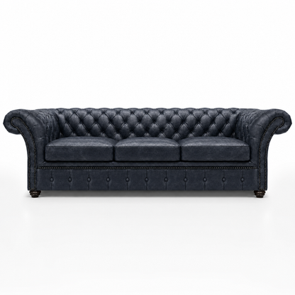 Dark blue tufted sofa on a white background
