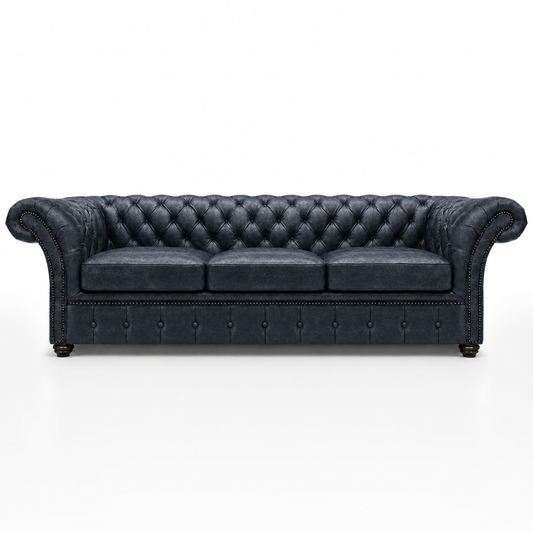 Dark blue tufted sofa on a white background
