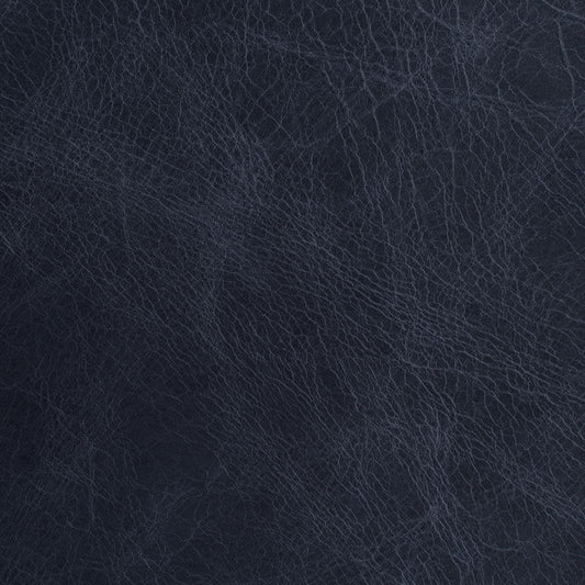 A close-up texture shot of dark navy blue leather with fine grain lines.