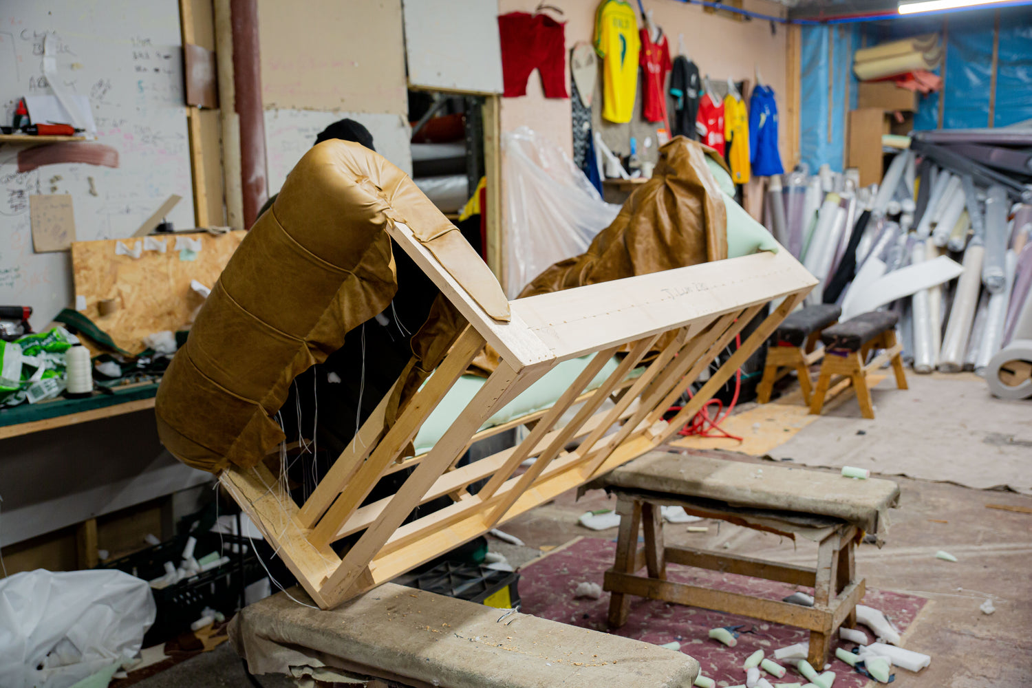 Wooden chair structure in a workshop setting with various items and tools around