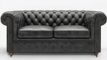 Grey leather chesterfield sofa on a white background